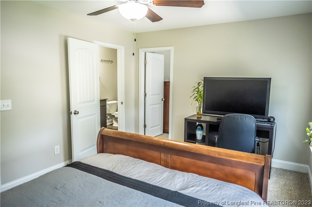 96 Eaker Drive Cameron, NC 28326 - Photo 32 of 41 a bedroom with a bed and a flat screen tv