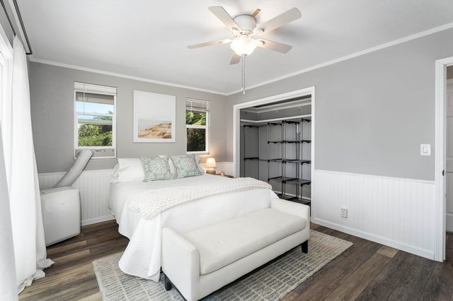 a bedroom with a bed and a book shelf