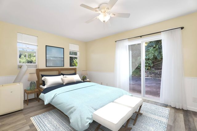 a bedroom with a large bed and a window