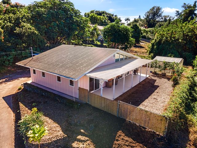 an aerial view of a house with a yard balcony and outdoor seating