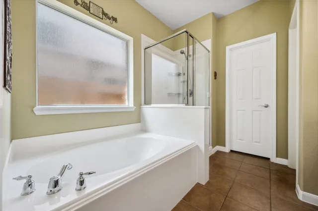 a bathroom with a bathtub and a shower