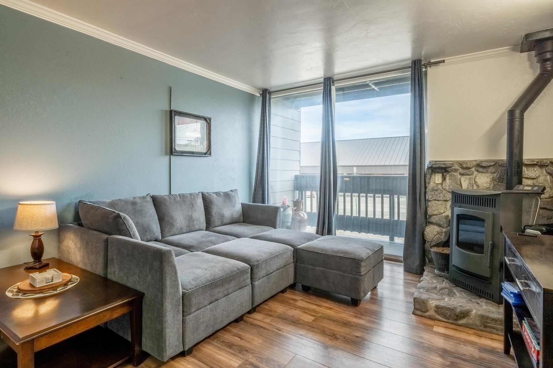 137 Laurel Mountain Road, Unit 312 Mammoth Lakes, CA 93546 - Photo 5 of 37 a living room with furniture and a fireplace