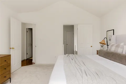 a bedroom with a bed and window