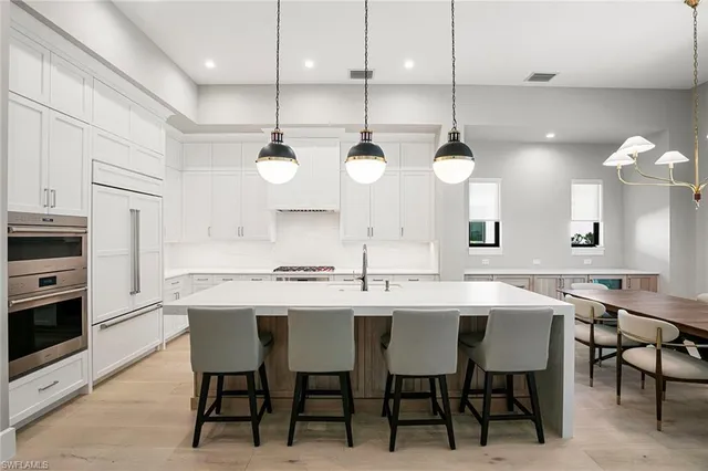 a kitchen with a sink cabinets and appliances