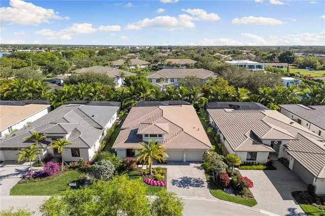an aerial view of a house with a yard and potted plants