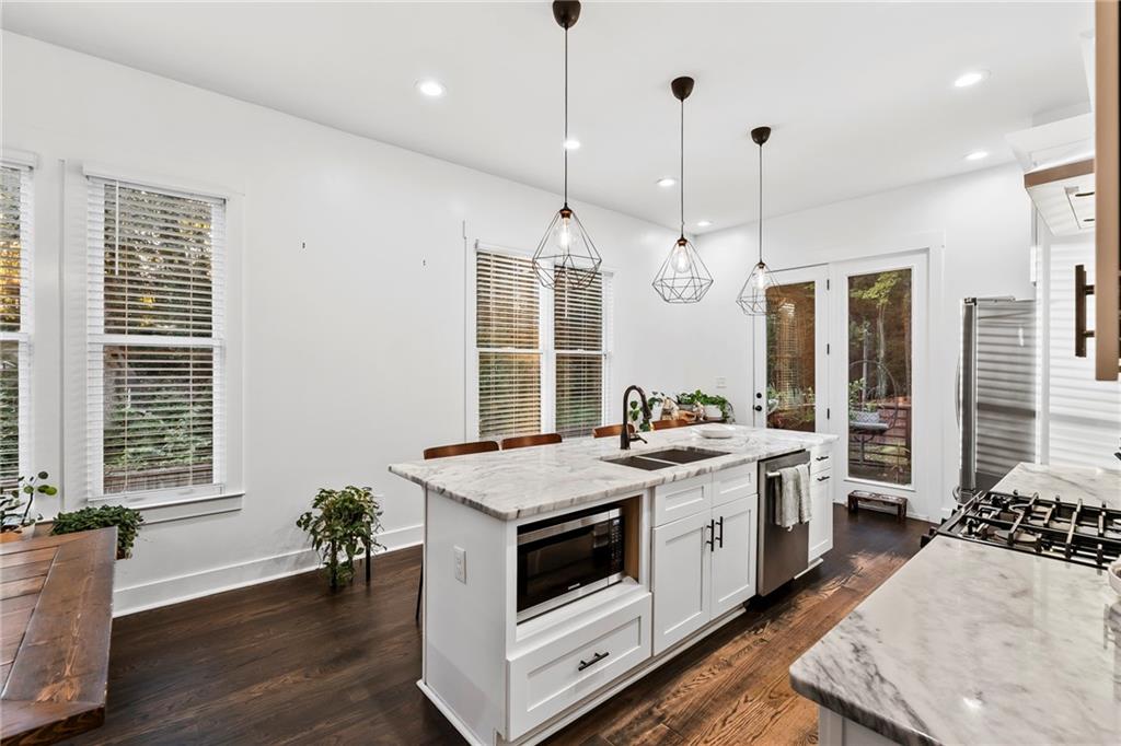 1771 Derry Avenue Southwest Atlanta, GA 30310 - Photo 13 of 45 a kitchen that has a stove a sink a counter space and wooden floor