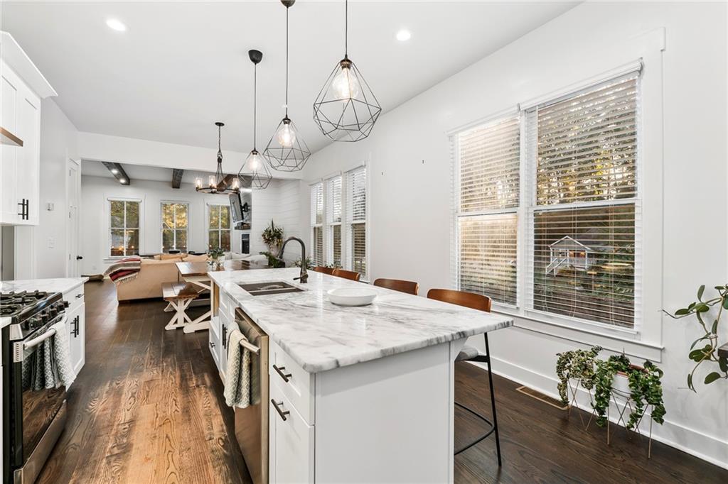 1771 Derry Avenue Southwest Atlanta, GA 30310 - Photo 14 of 45 a open kitchen with stainless steel appliances granite countertop a stove and a wooden floors