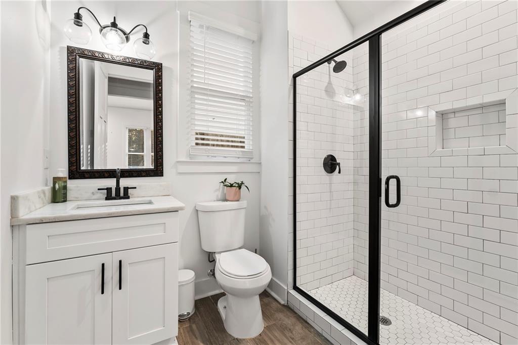 1771 Derry Avenue Southwest Atlanta, GA 30310 - Photo 21 of 45 a bathroom with a toilet sink a shower and