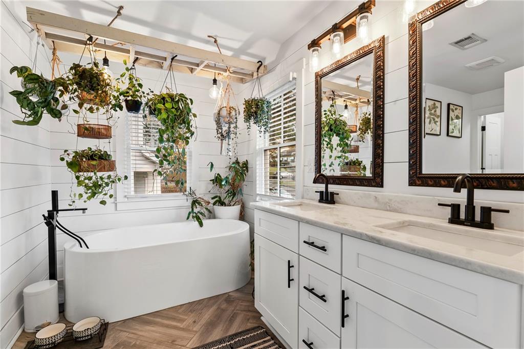 1771 Derry Avenue Southwest Atlanta, GA 30310 - Photo 26 of 45 a bathroom with a double vanity sink a mirror and a bathtub
