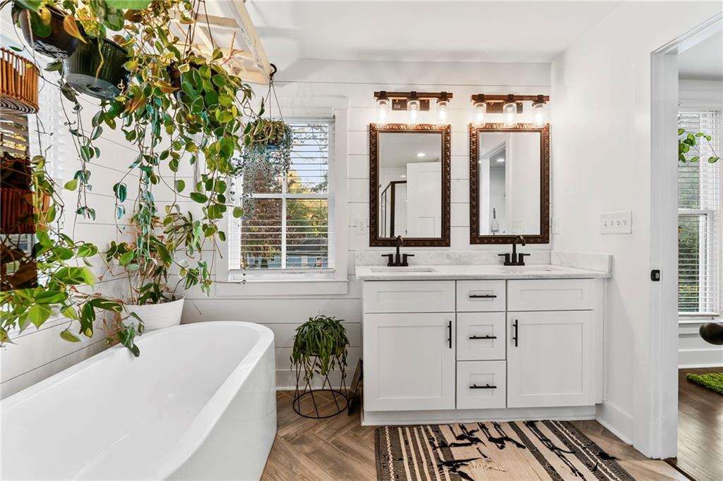1771 Derry Avenue Southwest Atlanta, GA 30310 - Photo 29 of 45 a bathroom with a bathtub sink and mirror