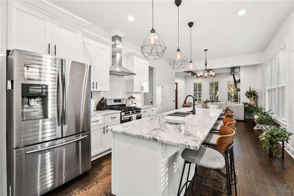 1771 Derry Avenue Southwest Atlanta, GA 30310 - Photo 7 of 45 a kitchen with stainless steel appliances kitchen island a refrigerator and a table