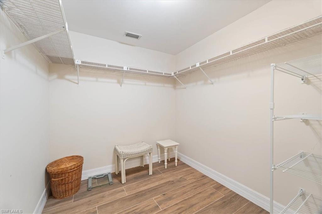 3012 Sandpiper Bay Circle, Unit D101 Naples, FL 34112 - Photo 13 of 27 a view of a room with racks on the wall