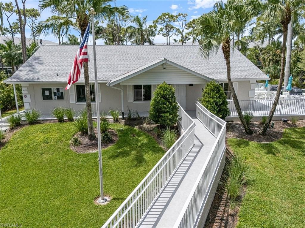 3012 Sandpiper Bay Circle, Unit D101 Naples, FL 34112 - Photo 21 of 27 a front view of house with yard and green space