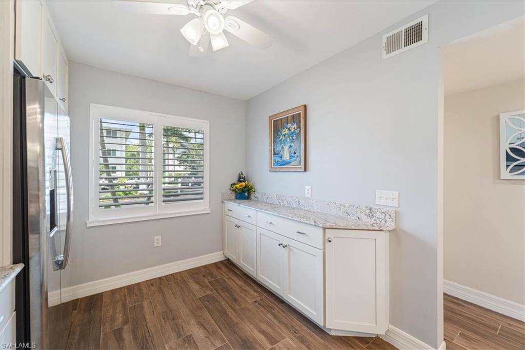 3012 Sandpiper Bay Circle, Unit D101 Naples, FL 34112 - Photo 4 of 27 a room with a sink cabinets and a window