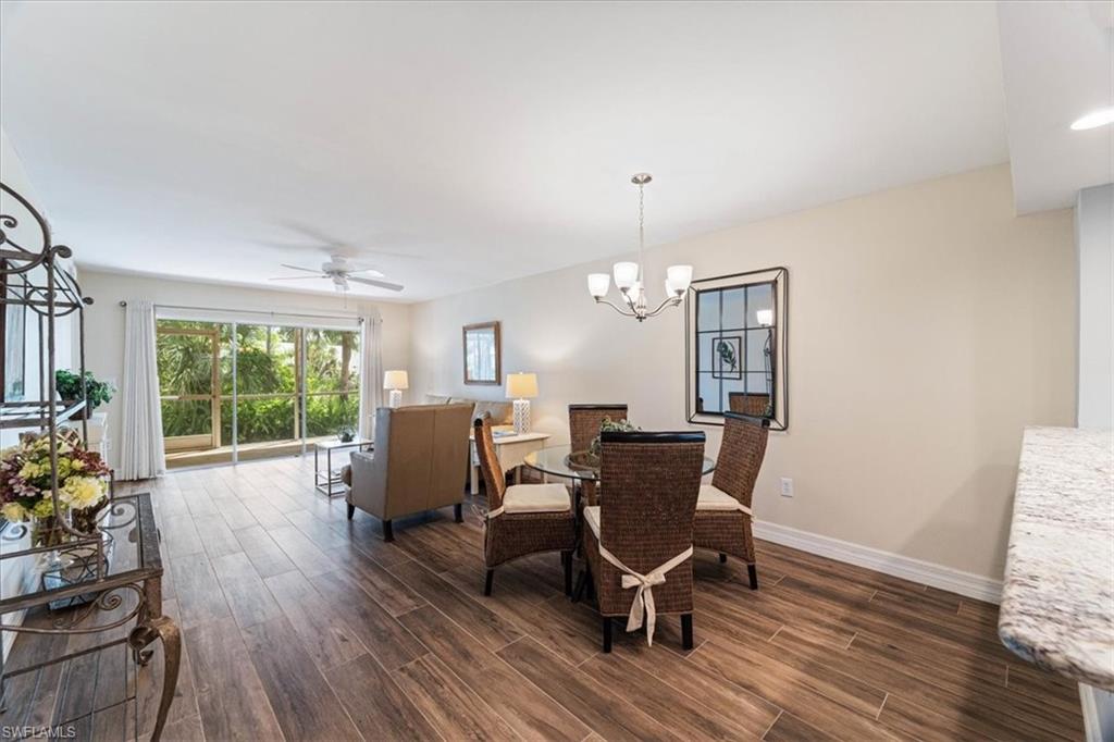 3012 Sandpiper Bay Circle, Unit D101 Naples, FL 34112 - Photo 5 of 27 a view of a dining room with furniture window and outside view