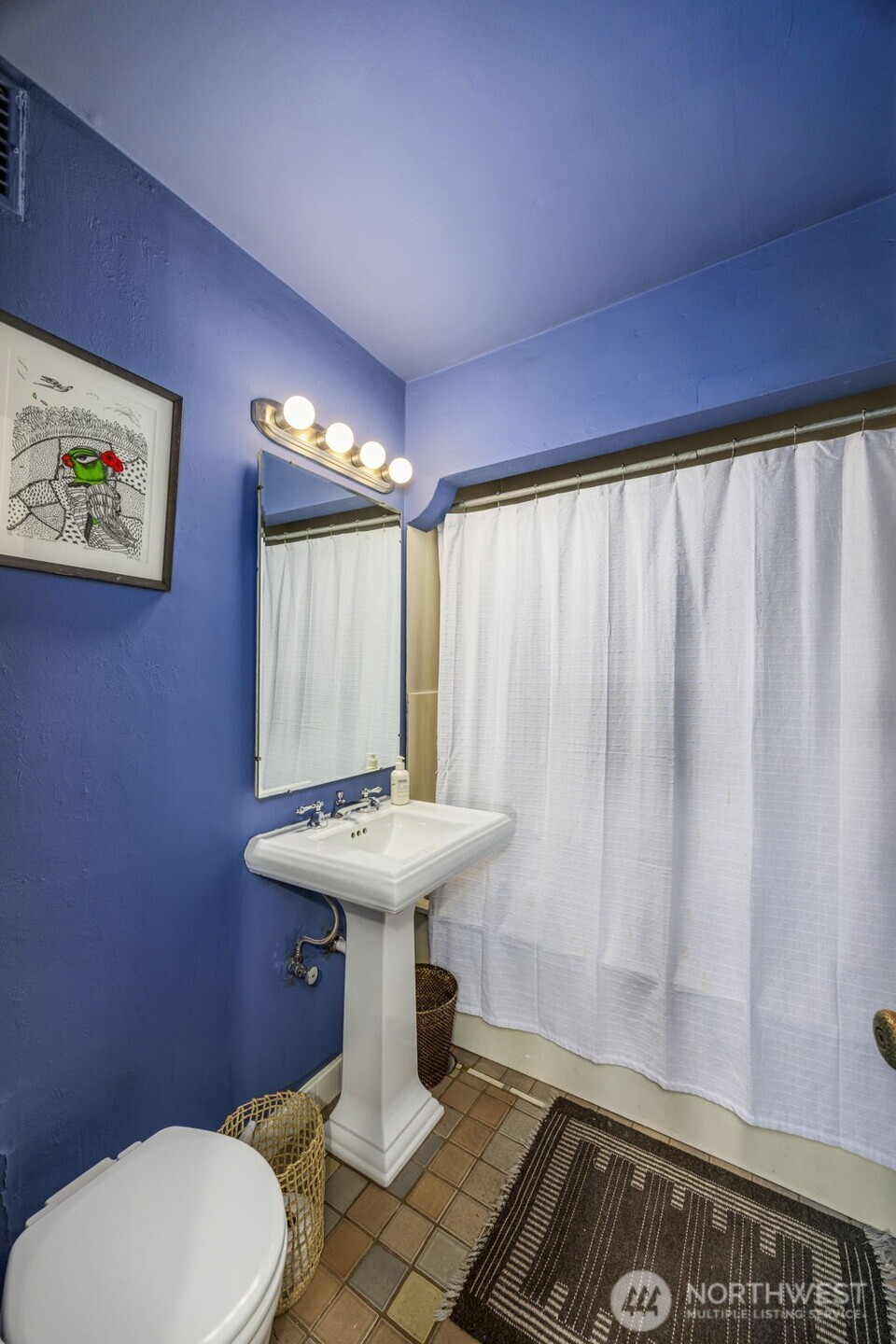 1014 East Roy Street, Unit 35 Seattle, WA 98102 - Photo 14 of 18 a bathroom with a sink toilet and shower curtain