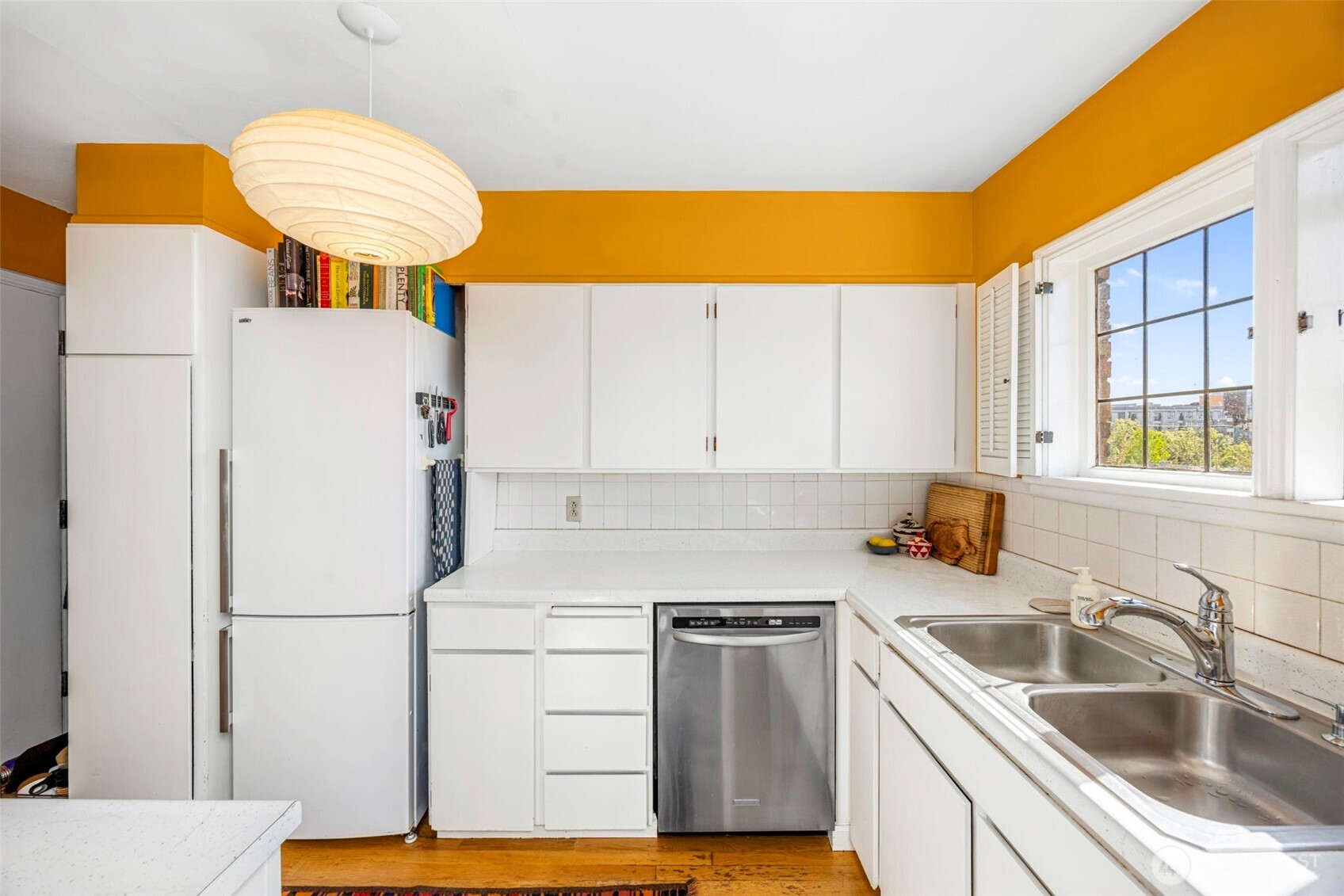 1014 East Roy Street, Unit 35 Seattle, WA 98102 - Photo 9 of 18 a kitchen with a sink a refrigerator and a stove