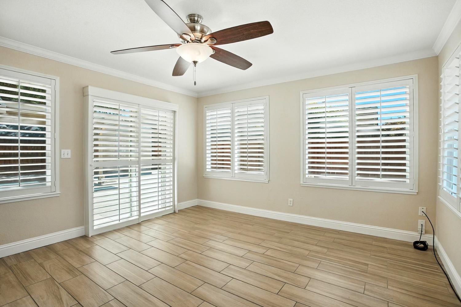 906 Ranch Road Galt, CA 95632 - Photo 13 of 38 bonus room featuring crown molding, wood finish floors, and ceiling fan