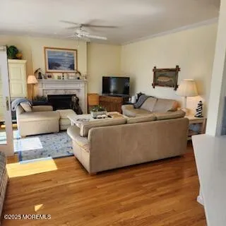 a living room with furniture a flat screen tv and a fireplace