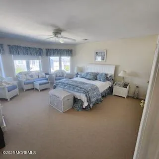 a spacious bedroom with a bed couch and window