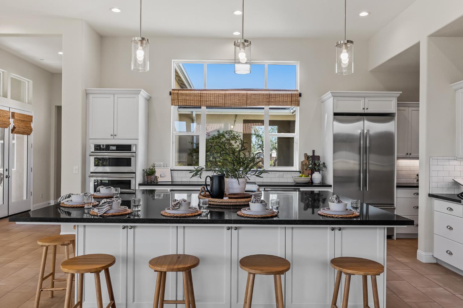 998 Highland Road West Madera, CA 93636 - Photo 14 of 61 a kitchen with stainless steel appliances a table and chairs in it