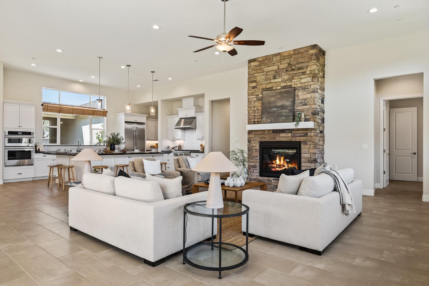 998 Highland Road West Madera, CA 93636 - Photo 21 of 61 a living room with furniture a fireplace and a chandelier