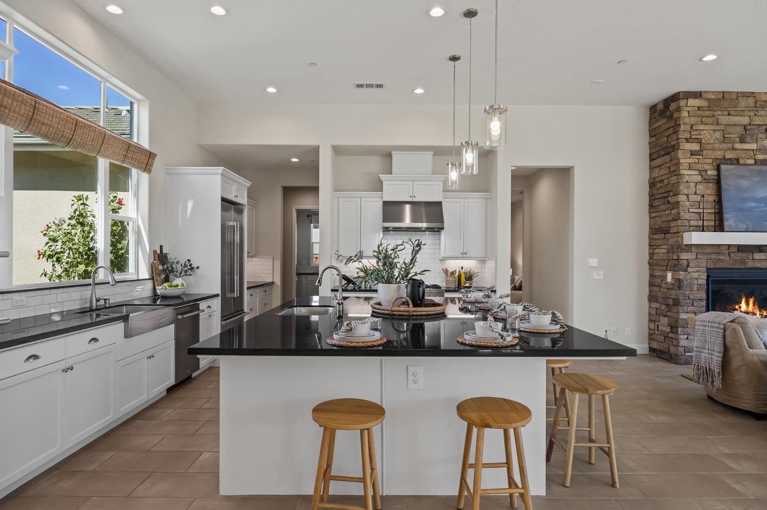 998 Highland Road West Madera, CA 93636 - Photo 3 of 61 a kitchen with kitchen island granite countertop a table and chairs in it