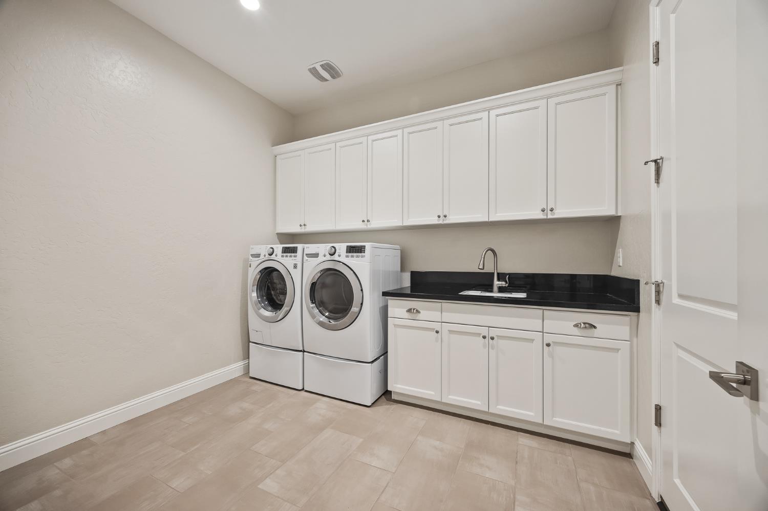 998 Highland Road West Madera, CA 93636 - Photo 34 of 61 a utility room with sink dryer and washer
