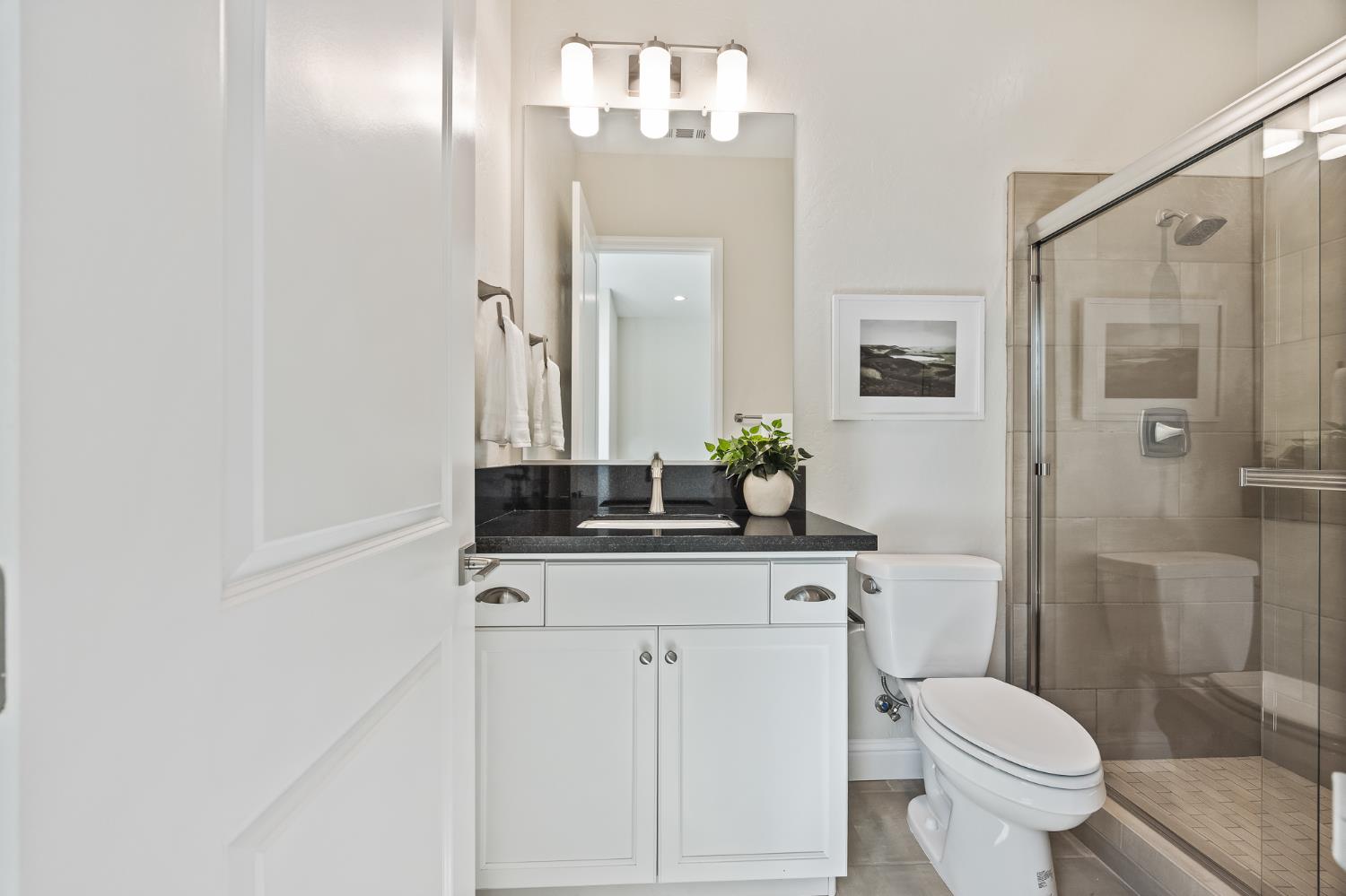 998 Highland Road West Madera, CA 93636 - Photo 38 of 61 a bathroom with a granite countertop sink toilet and shower