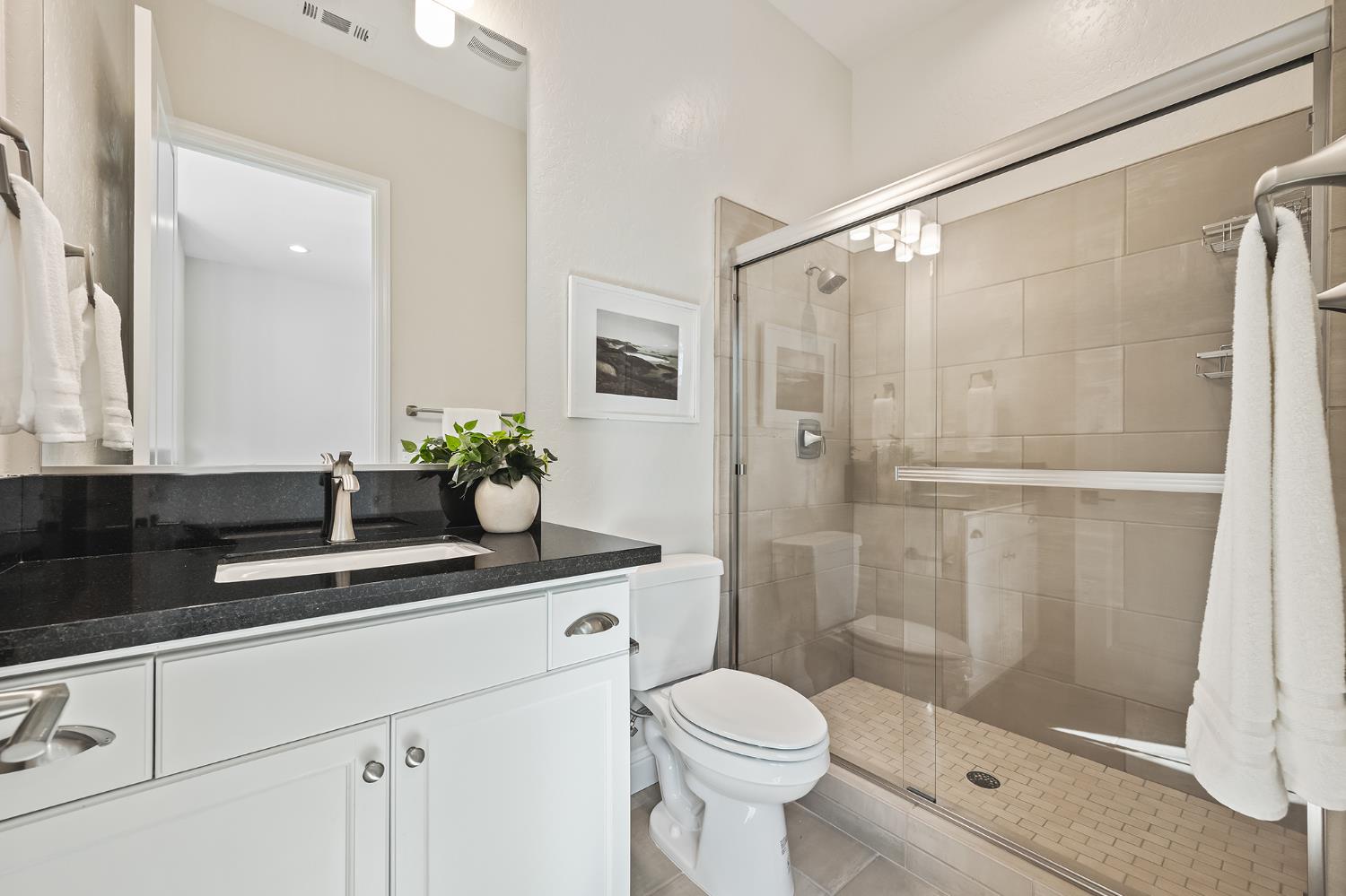 998 Highland Road West Madera, CA 93636 - Photo 39 of 61 a bathroom with a shower sink vanity mirror and toilet
