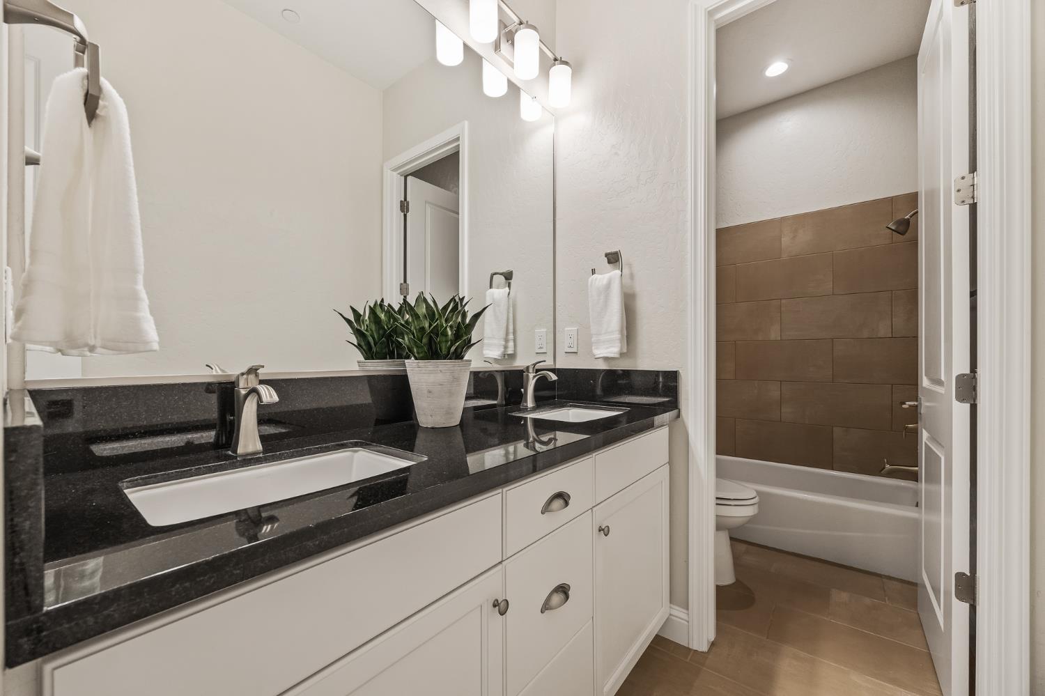 998 Highland Road West Madera, CA 93636 - Photo 47 of 61 a bathroom with a double vanity sink a mirror and a shower