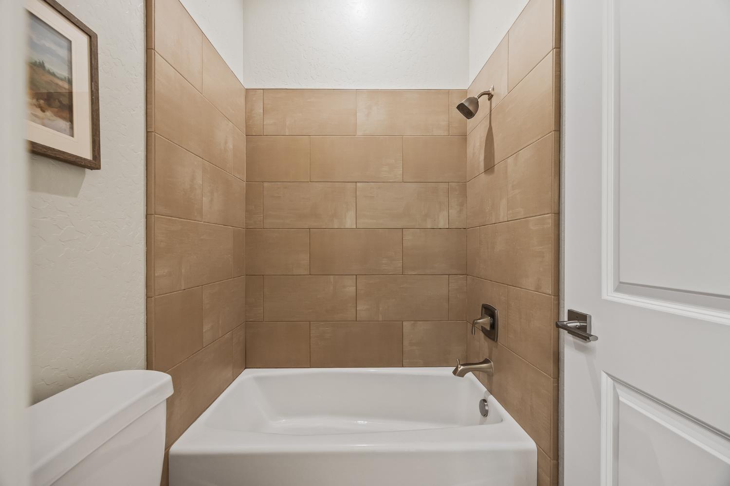 998 Highland Road West Madera, CA 93636 - Photo 48 of 61 a white bath tub sitting next to a white toilet