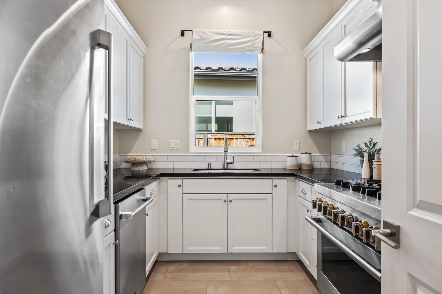 998 Highland Road West Madera, CA 93636 - Photo 5 of 61 a kitchen with stainless steel appliances granite countertop a sink stove and cabinets