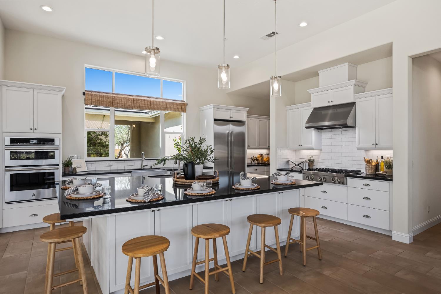 998 Highland Road West Madera, CA 93636 - Photo 8 of 61 a kitchen with granite countertop a table chairs sink and microwave