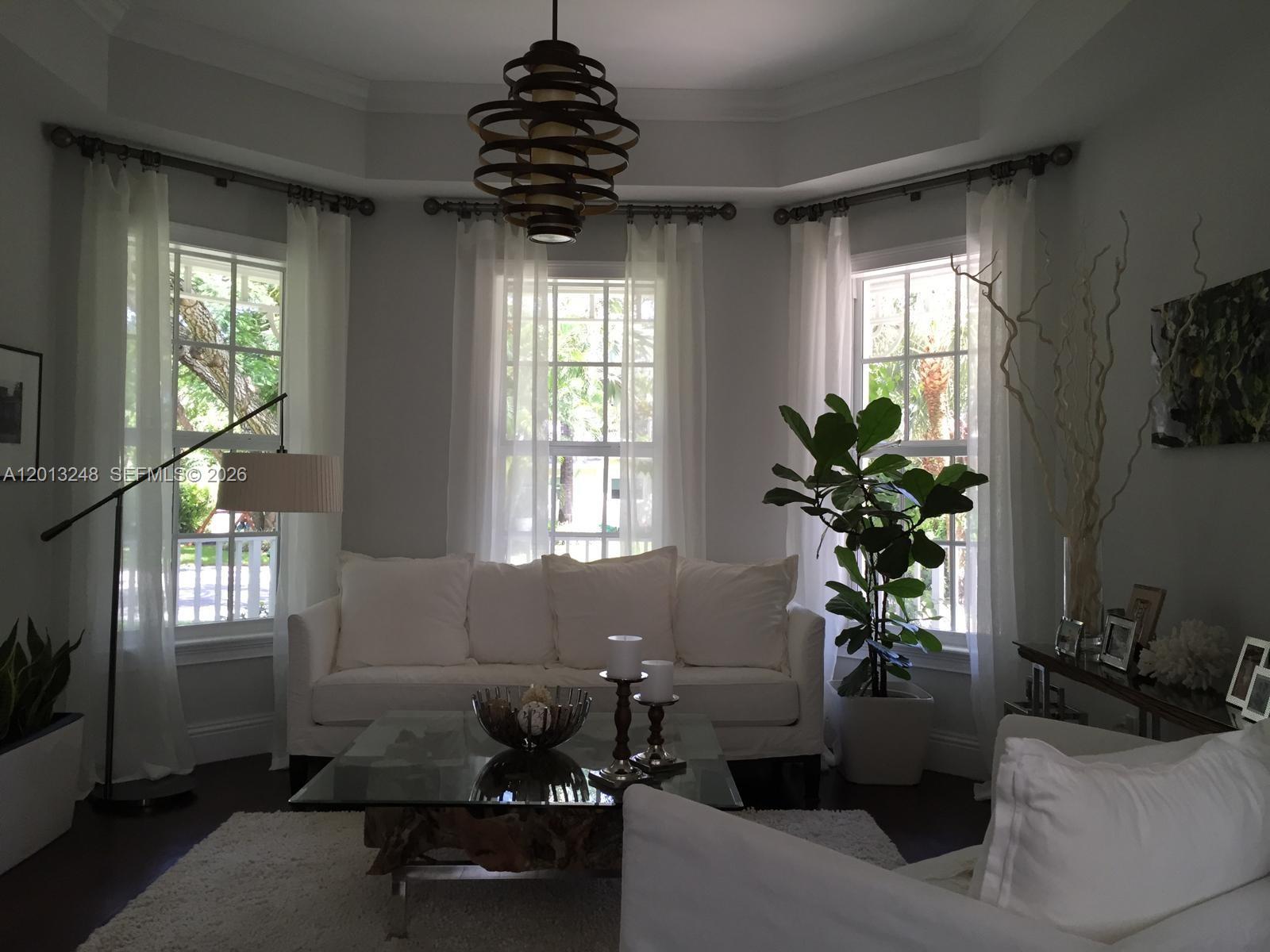 5000 Southwest 73rd Terrace Miami, FL 33143 - Photo 3 of 24 a living room with furniture and a chandelier