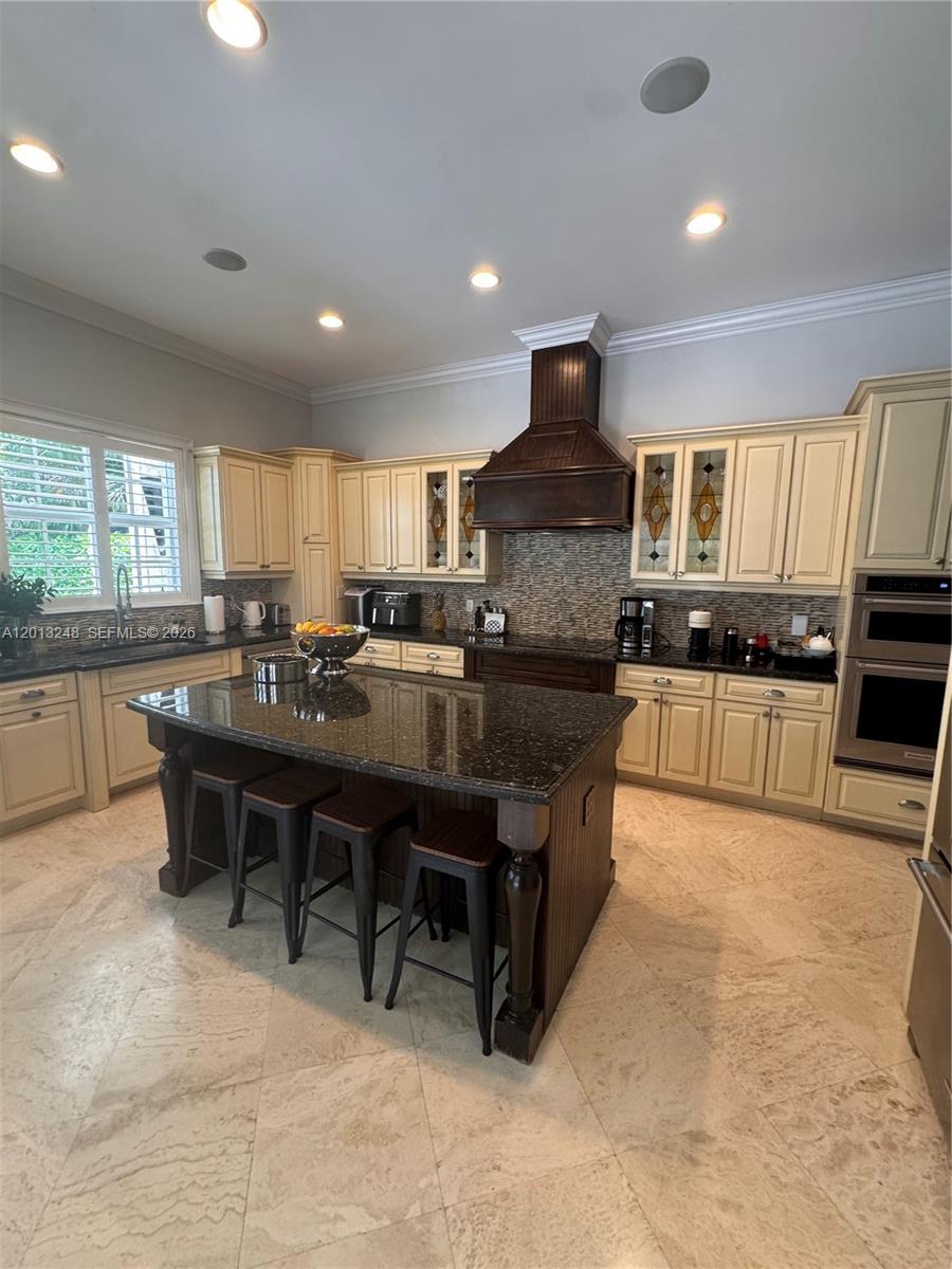 5000 Southwest 73rd Terrace Miami, FL 33143 - Photo 8 of 24 a kitchen with kitchen island granite countertop a sink a stove a oven a dining table and chairs