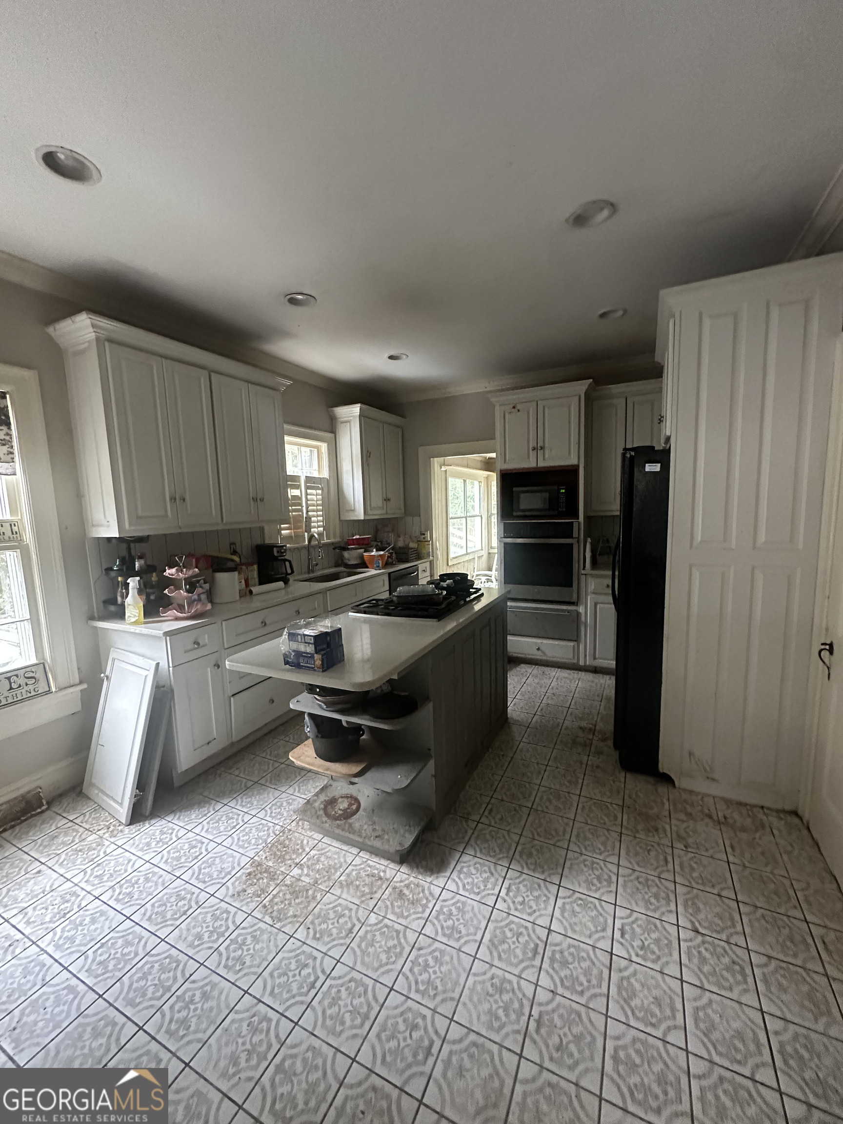 108 Charlton Street Northwest Rome, GA 30165 - Photo 5 of 7 a kitchen with stainless steel appliances a refrigerator sink and cabinets