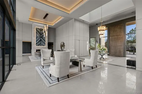a view of a living room with a floor to ceiling window and stairs