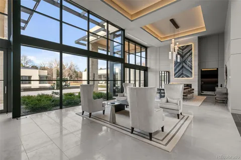 a living room with furniture fireplace and a large window