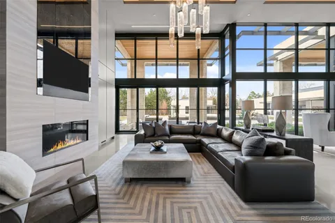 a living room with fireplace furniture and a large window