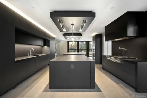 a large white kitchen with a large window