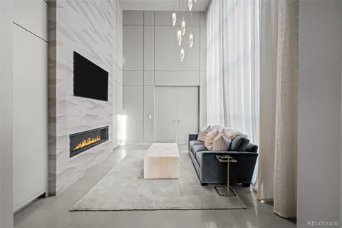 a spacious bedroom with a large bed and a chandelier