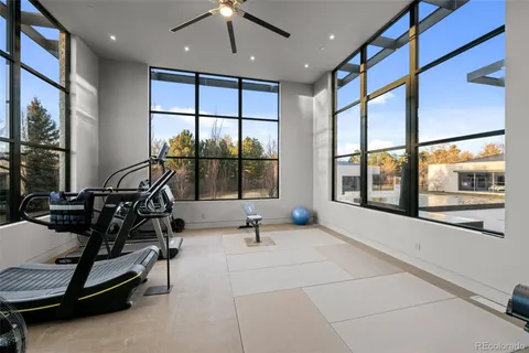 a dining room with furniture and a floor to ceiling window