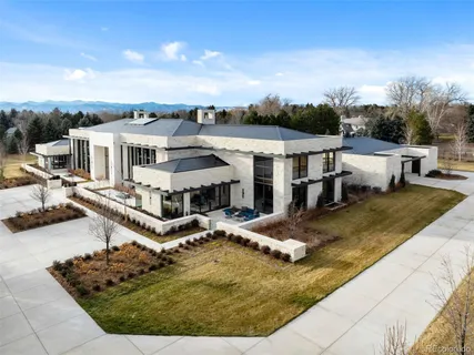 a front view of house with yard and lake view in back