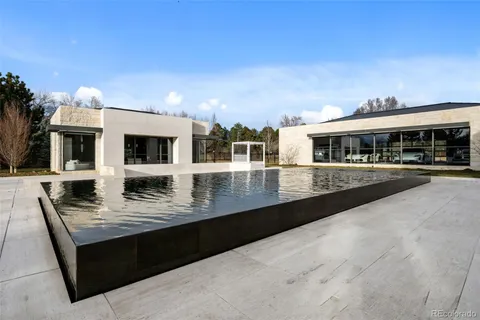 a view of a patio with table and chairs with wooden floor and view of kitchen