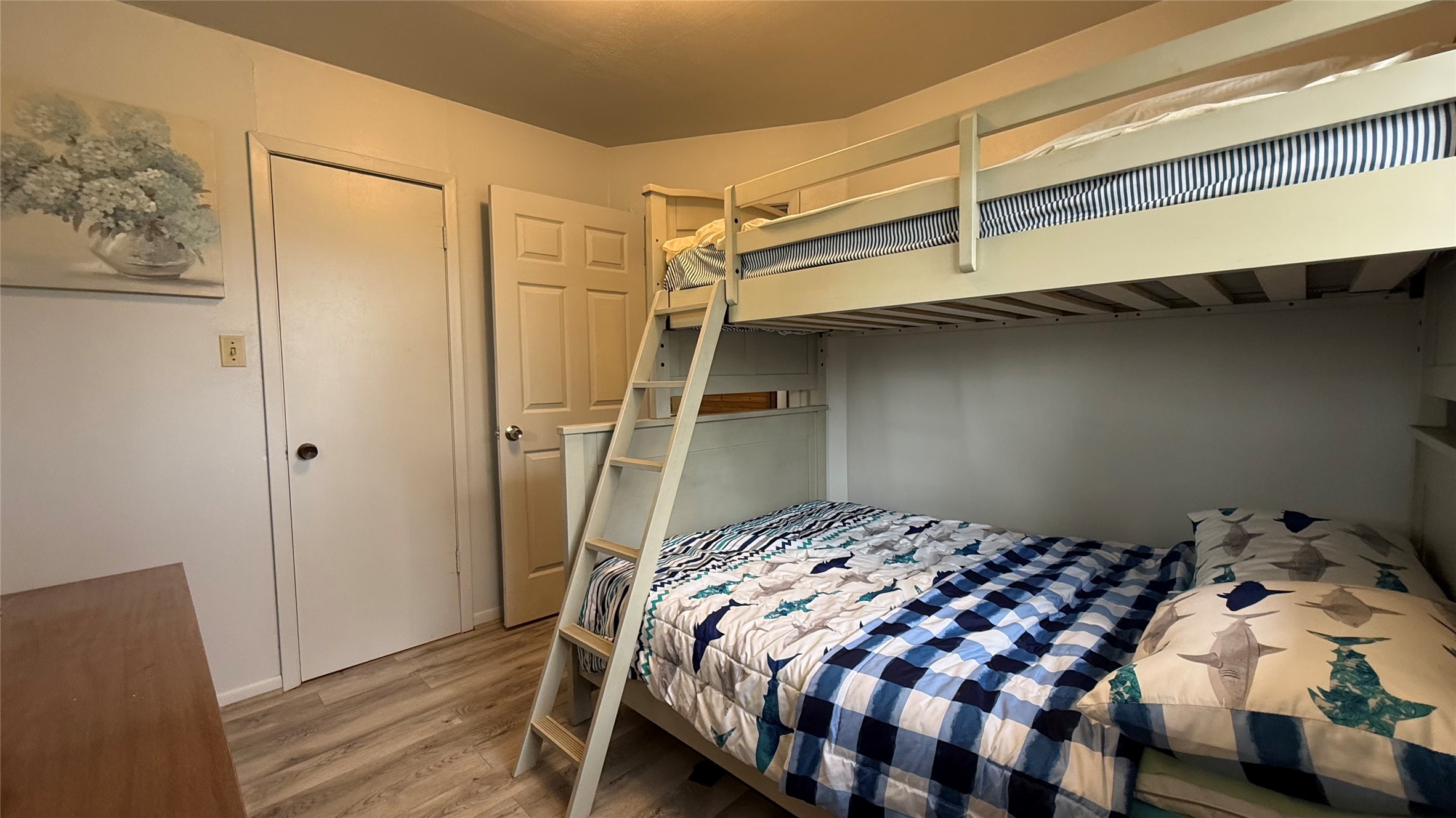 215 Weldon Livingston, TX 77351 - Photo 19 of 22 a bedroom with a bed and wooden floor