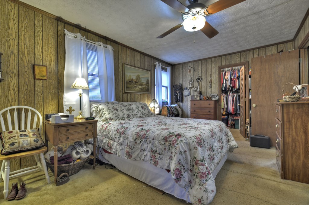 2800 Mobile Road Copperhill, TN 37317 - Photo 17 of 26 a bedroom with a bed and a chandelier