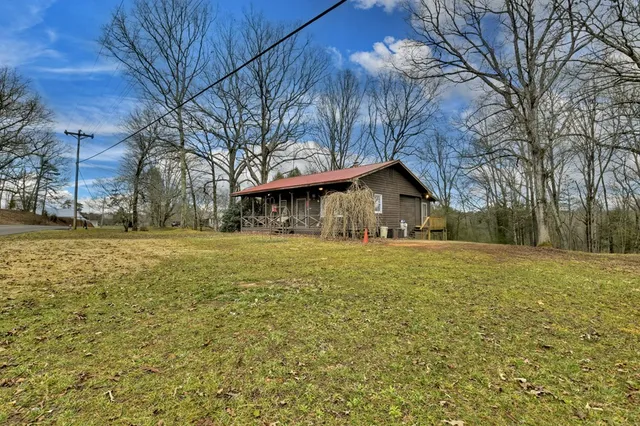 a front view of a house with yard outdoor seating and barbeque oven