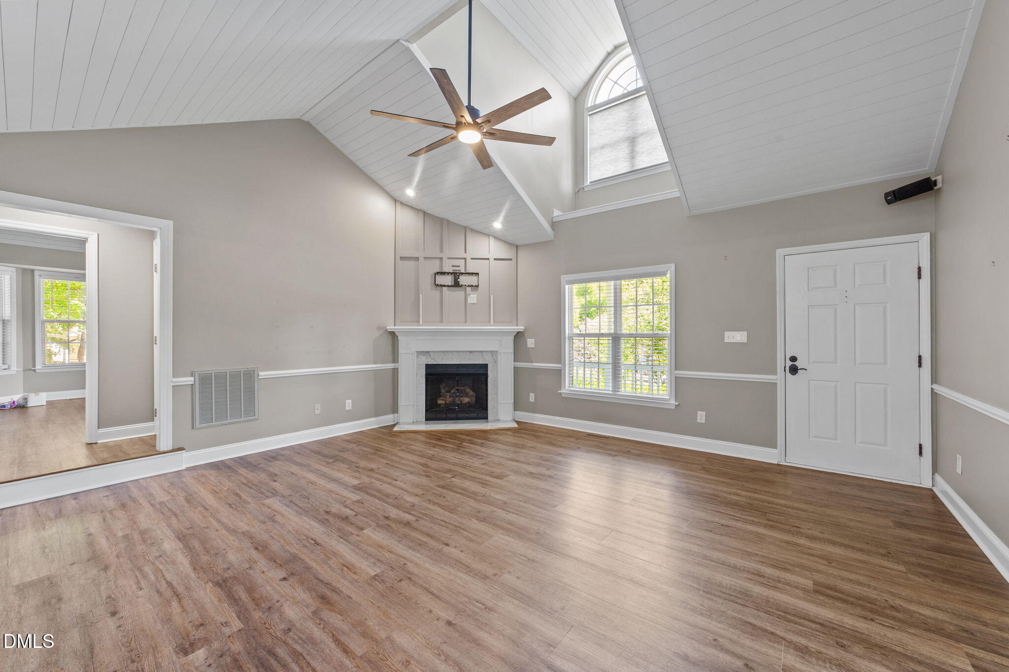 6820 Oviedo Drive Raleigh, NC 27603 - Photo 1 of 50 an empty room with wooden floor fireplace and windows