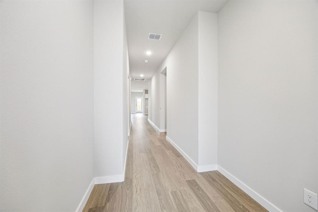 657 Poppy Lane Lavon, TX 75166 - Photo 26 of 28 a view of a hallway with wooden floor